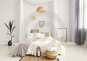 White and beige bedroom in boho style with macrame