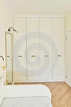 White beige pastel built-in wardrobe in the color of wall