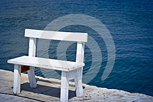 White bench on the coast