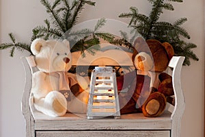 White bench with teddy bears and christmas sprig