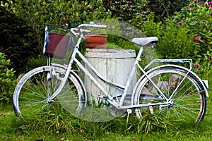 White bicycle or bike as garden decoration