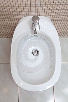 White bidet in bathroom top view