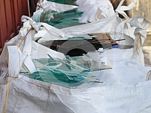 White big bags filled with pieces of sheet glass