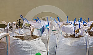White big bags full with potting soil, horticulture and agriculture industry, logistic background