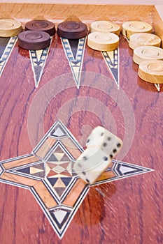 White big dices falling on wooden backgammon board