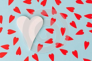 White big heart and small red hearts on the blue background