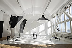 White big huge cyclorama in modern professional photo studio with a professional equipment, ligts, stands and soft boxes