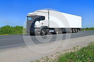 A White Big Tractor Trailer Truck with semitrailer