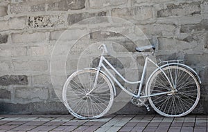 White bike on concrete wall background