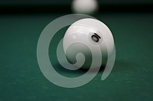 White billiard balls covered on a table with a green cloth