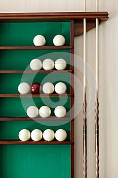White billiard balls and cue ball for Russian billiards on the shelf