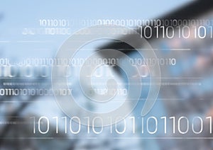 White binary code against blurry building