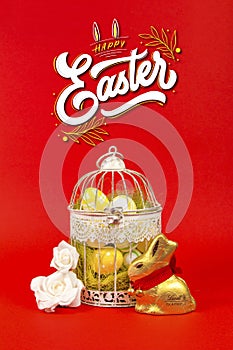 White bird cage with Easter eggs in it on a red background