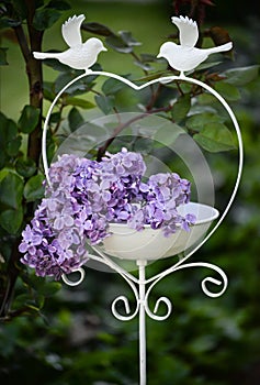 White bird feeder with lilac