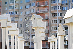 Birdhouses standing in front of an apartment building