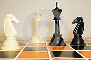 White and black chess pieces on game board