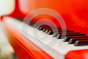 White and black keys of red piano