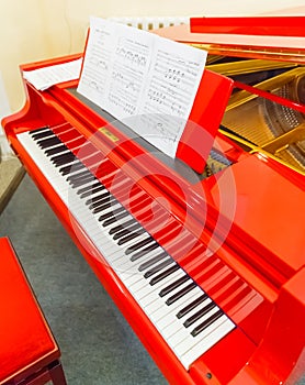 White and black keys of red piano