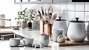 White and black kitchen with pots and pans on counter