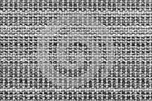 White and black knitted fabric background texture. gray fabric with a pattern. Fragment grey wool carpet, bright wicker dark rug