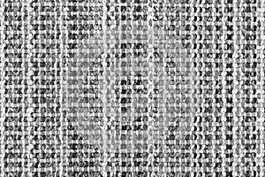 White and black knitted fabric background texture. gray fabric with a pattern. Fragment grey wool carpet, bright wicker dark rug