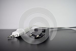 White and black plugs on black and white background photo