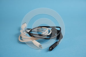 White and black wires with different usb interfaces on a blue background.
