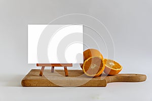 White Blank Banner Mock Up On The Cutting Board With Fresh Orange.Isolated Template Clipping Path
