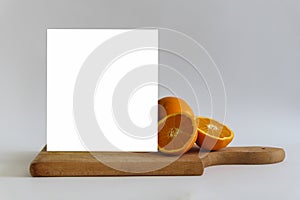 White Blank Banner Mock Up On The Cutting Board With Fresh Orange.Isolated Template Clipping Path