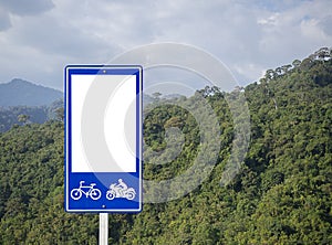 White blank of bike and bicycle route direction signs with mountaion and cloudy sky behind