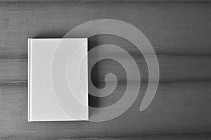 White blank book cover on table. Minimalist composition top view.