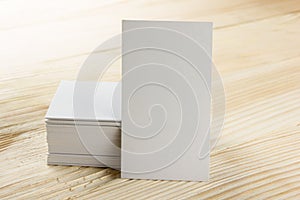 White blank business visit card, gift, ticket, pass, present close up on wooden background. Copy space Blank corporate identity p