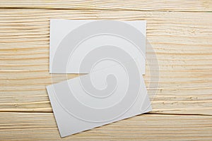 White blank business visit card, gift, ticket, pass, present close up on wooden background. Copy space Blank corporate identity p