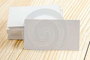 White blank business visit card, gift, ticket, pass, present close up on wooden background. Copy space Blank corporate identity p