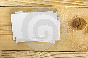 White blank business visit card, gift, ticket, pass, present close up on wooden background. Copy space Blank corporate identity p