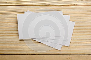 White blank business visit card, gift, ticket, pass, present close up on wooden background. Copy space Blank corporate identity p