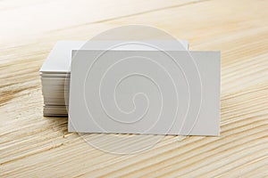 White blank business visit card, gift, ticket, pass, present close up on wooden background. Copy space Blank corporate identity p