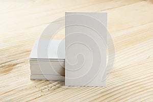 White blank business visit card, gift, ticket, pass, present close up on wooden background. Copy space Blank corporate identity p