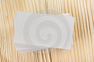 White blank business visit card, gift, ticket, pass, present close up on wooden background. Copy space Blank corporate identity p