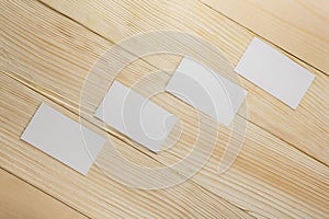 White blank business visit card, gift, ticket, pass, present close up on wooden background. Copy space Blank corporate identity p