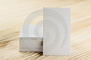 White blank business visit card, gift, ticket, pass, present close up on wooden background. Copy space Blank corporate identity p