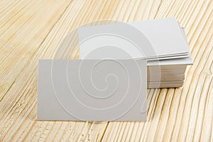 White blank business visit card, gift, ticket, pass, present close up on wooden background. Copy space Blank corporate identity p