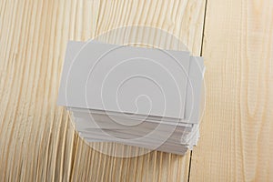 White blank business visit card, gift, ticket, pass, present close up on wooden background. Copy space Blank corporate identity p