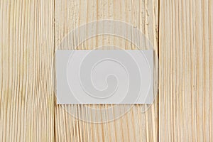 White blank business visit card, gift, ticket, pass, present close up on wooden background. Copy space Blank corporate identity p