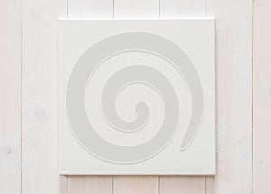 White blank canvas mockup square size on white wood wall for arts painting and photo hanging decoration
