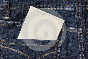 A white blank card in a dark blue jeans pocket for text, copy space