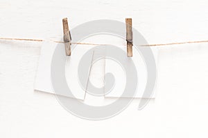 White blank cards on rope, light wall background