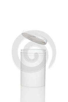 White blank opened plastic container stay on the surface. levitating lid is jump up. Isolated on white background. Close up view