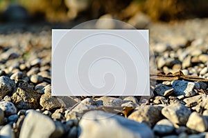 White blank paper card mockup. Blank card board standing on nature sea beach, ocean, pebbles background