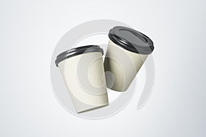 White blank paper coffee cups with black plastic caps at white background. Mock up
